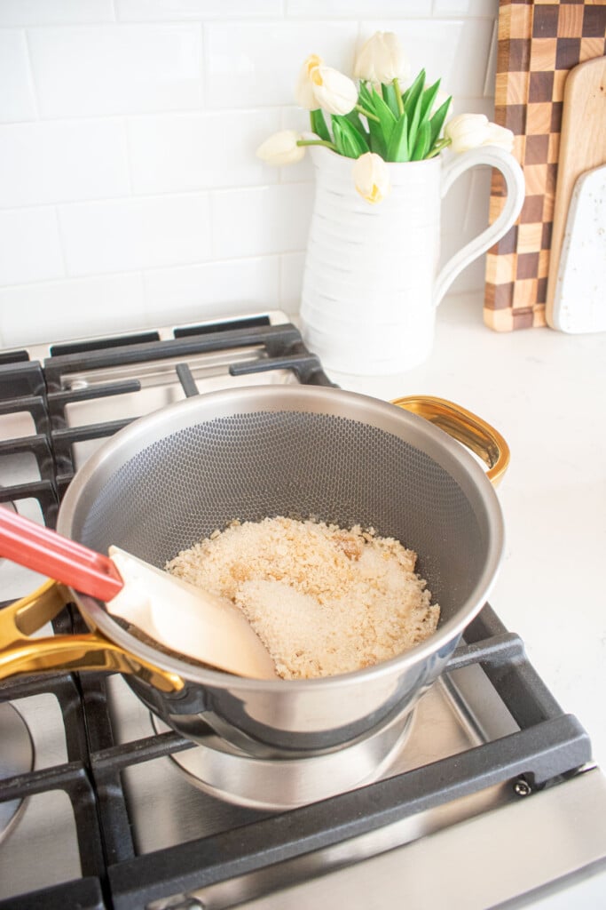 saucepan on the stovetop with cane sugar being melted.