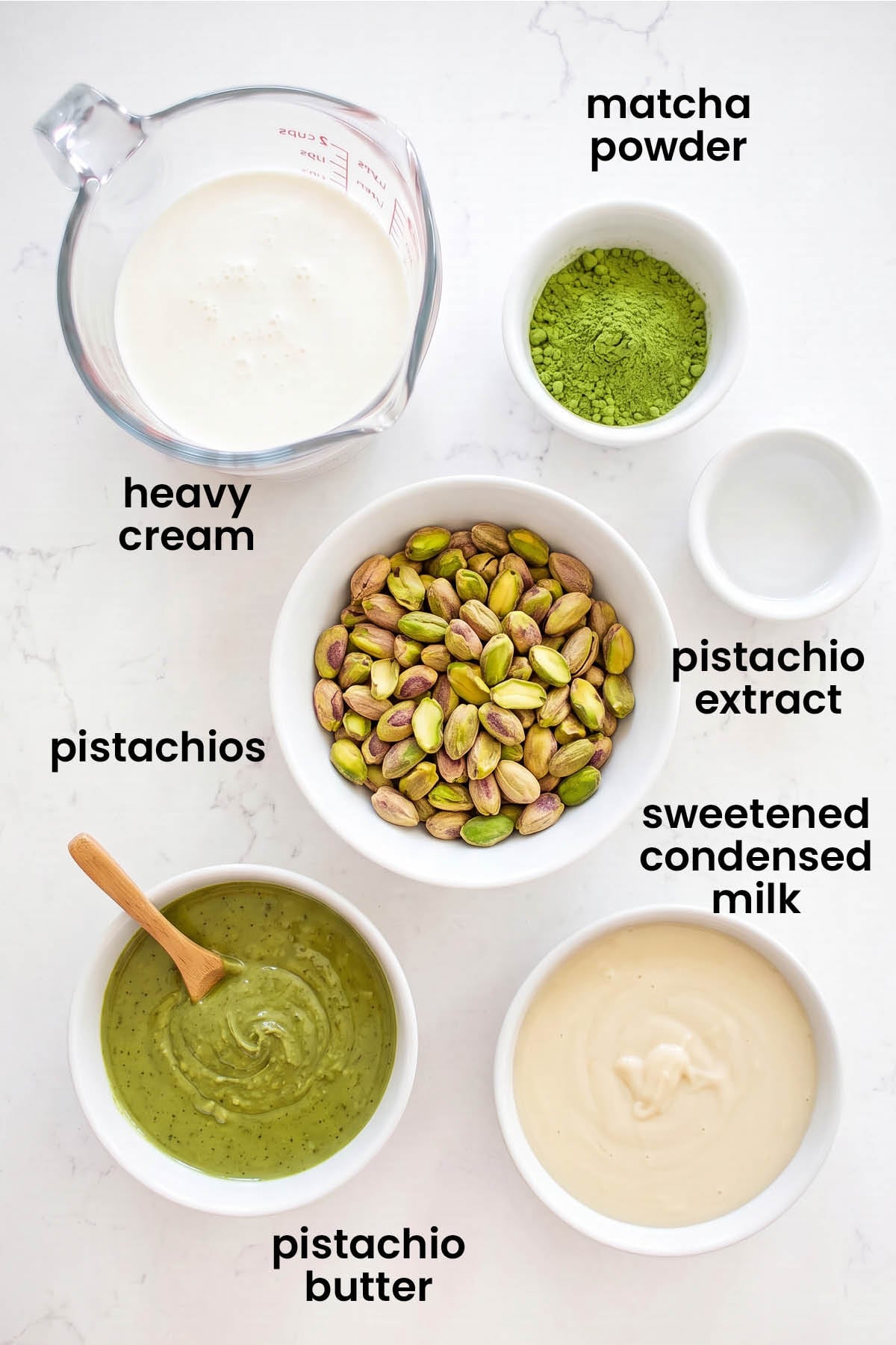 individual ingredients for pistachio matcha no churn ice cream laid out against a white background.