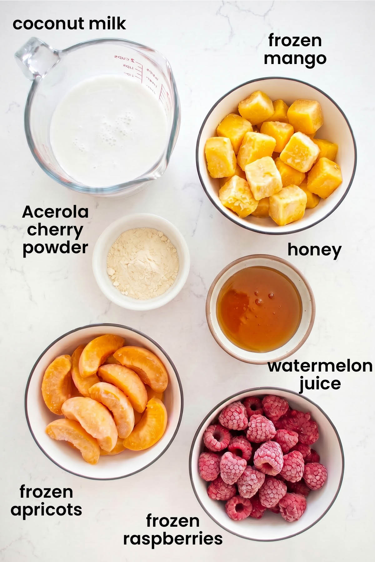 individual ingredients for raspberry apricot smoothie laid out against a white background.