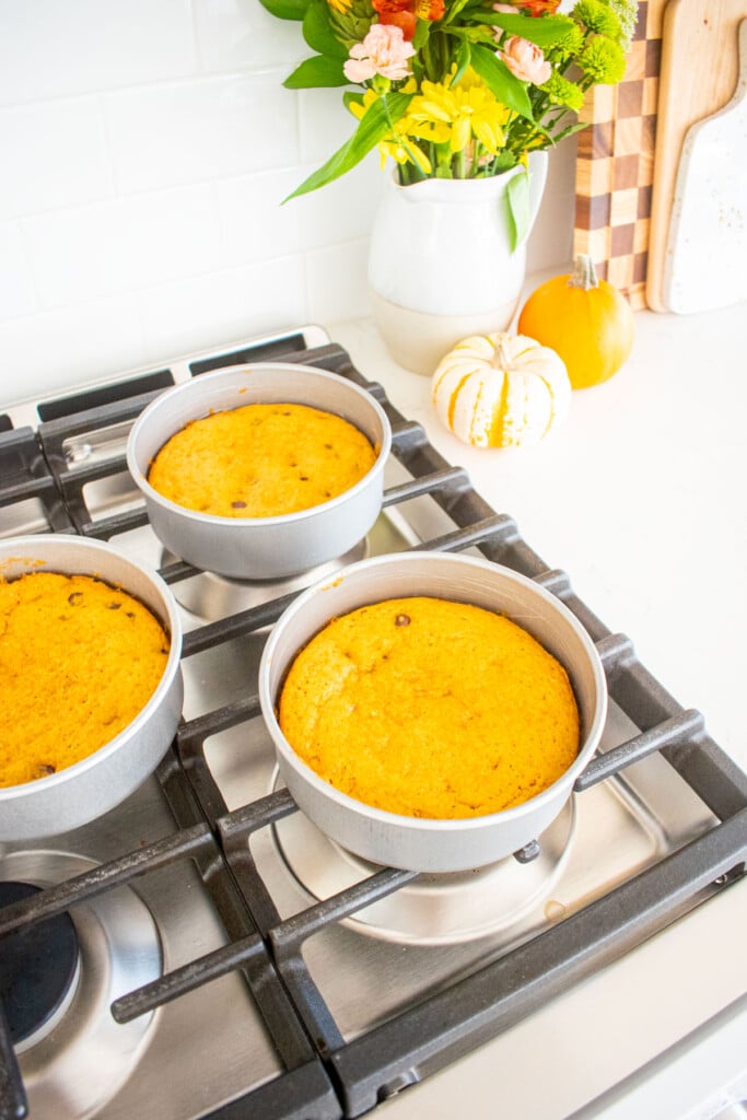 baked pumpkin chocolate chip layer cakes cooling on a stovetop.
