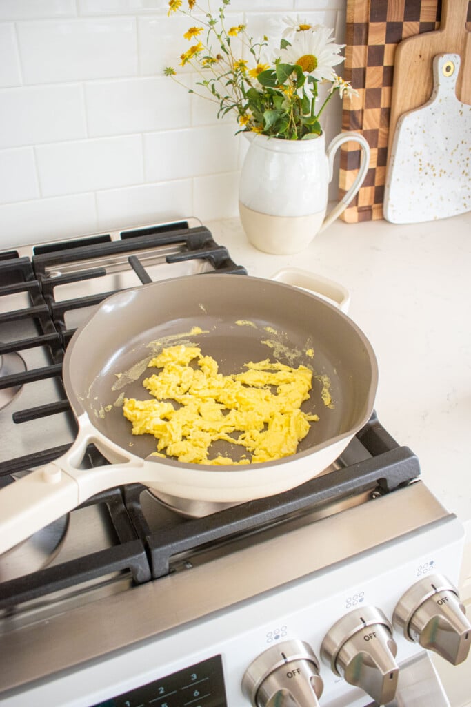 scrambled eggs in a large skillet on the stovetop.